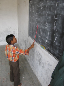 School Boy Learning Alphabet in Noah's Ark Sponsored School